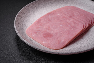 Delicious fresh ham cut into slices with salt, spices and herbs