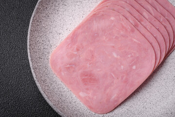Delicious fresh ham cut into slices with salt, spices and herbs