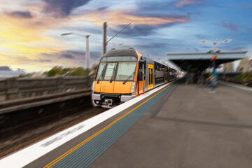 Commuter Train fast moving through a Station in Sydney NSW Australia locomotive electric light rail