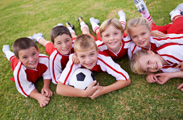 Children, soccer team and portrait with ball, boys and girls on field, happy and united. Energy,...