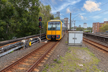 Commuter Train fast moving through a Station in Sydney NSW Australia locomotive electric light rail