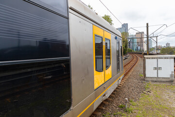 Commuter Train fast moving through a Station in Sydney NSW Australia locomotive electric light rail