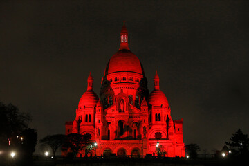 The Sacred Heart basilica lit up in red by Aide a l'Eglise en Detresse charity, Paris, France