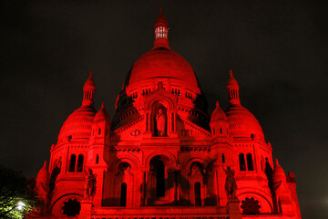 The Sacred Heart basilica lit up in red by Aide a l'Eglise en Detresse charity, Paris, France