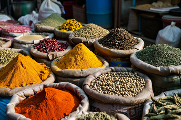 Bags with colourful spice in market in India. Close up baskets Packed with colorful Spices, grains, nuts and Herbs for Diverse Culinary Experiences. Copy space