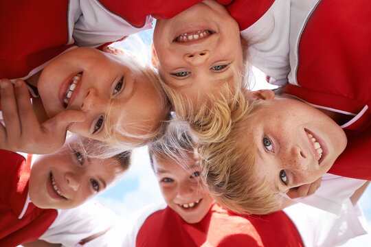 Children, portrait and soccer team huddle in outdoors, happy and collaboration or support. People, kids and boys together for match and partnership, smiling and solidarity in circle by sky background