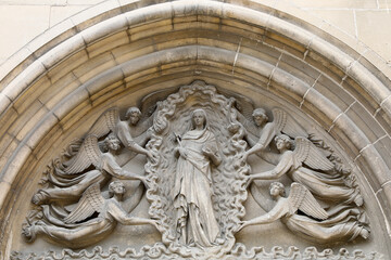 Fototapeta na wymiar Ympanum of Our Lady of Assumption church, Auvers-sur-Oise, France