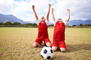 Children, soccer team and cheering for success and celebration, happy and victory in outdoors. People, kids and excited for achievement, collaboration and partnership or teamwork on field or sports