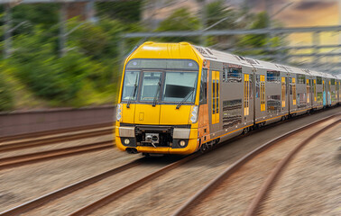 Commuter Train fast moving through a Station in Sydney NSW Australia locomotive electric light rail