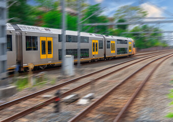 Commuter Train fast moving through a Station in Sydney NSW Australia locomotive electric light rail
