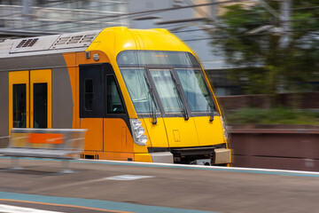 Commuter Train fast moving through a Station in Sydney NSW Australia locomotive electric light rail