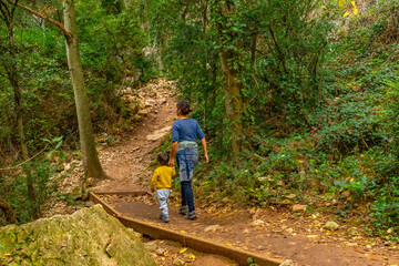 Woman with her son on the Vero River footbridge path in Alquezar. Huesca Pyrenees