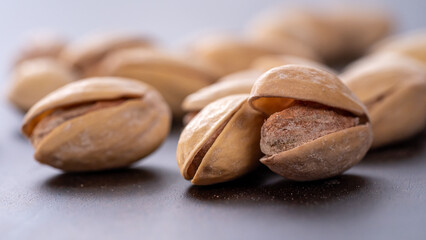 Macro View of Pistachio Nuts on Wooden Table - Pistachios Background