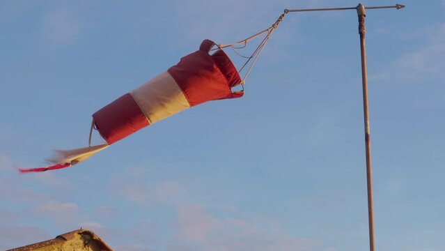 Old windsock swaying in the wind at sunset. 4k, h265, 30 fps, 4:2:2 10 bit (BT709).