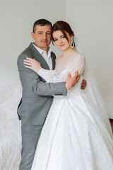 A beautiful bride with her father on her wedding day. The best moments of the wedding day. Daughter and father.