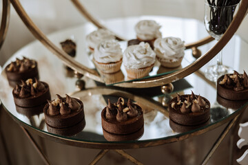 Almond cookies and various sweet cakes for a wedding banquet. A delicious reception, a luxurious ceremony. Table with sweets and desserts. Delicious colorful French desserts on a plate or table.