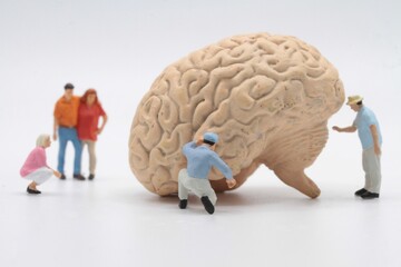 miniature characters around a human brain