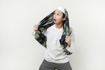 asian muslim man with funny expression. People religious Islam lifestyle concept. celebration Ramadan and ied Mubarak. on isolated background.
