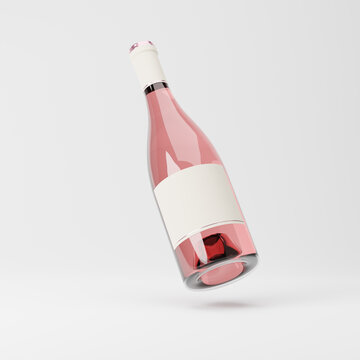 Falling heavy glass bottle of rose wine with blank label isolated over white background. Mockup template. 3d rendering.