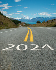 New Year 2024. Text 2024 written on the Mt Cook road. Snow-capped Mt Cook in the distance, South...