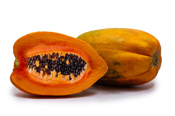 whole and half of ripe papaya fruit with seeds isolated on white background