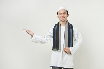 asian muslim man with presenting hand gesture. People religious Islam lifestyle concept. celebration Ramadan and ied Mubarak. on isolated background.