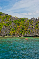 PALAWAN, PHILIPPINES - DECEMBER 21, 2023: Blue lagoon tropical landscape at the Coron island bay in Palawan province Philippines. 6 million foreign tourists visited Philippines in 2016.