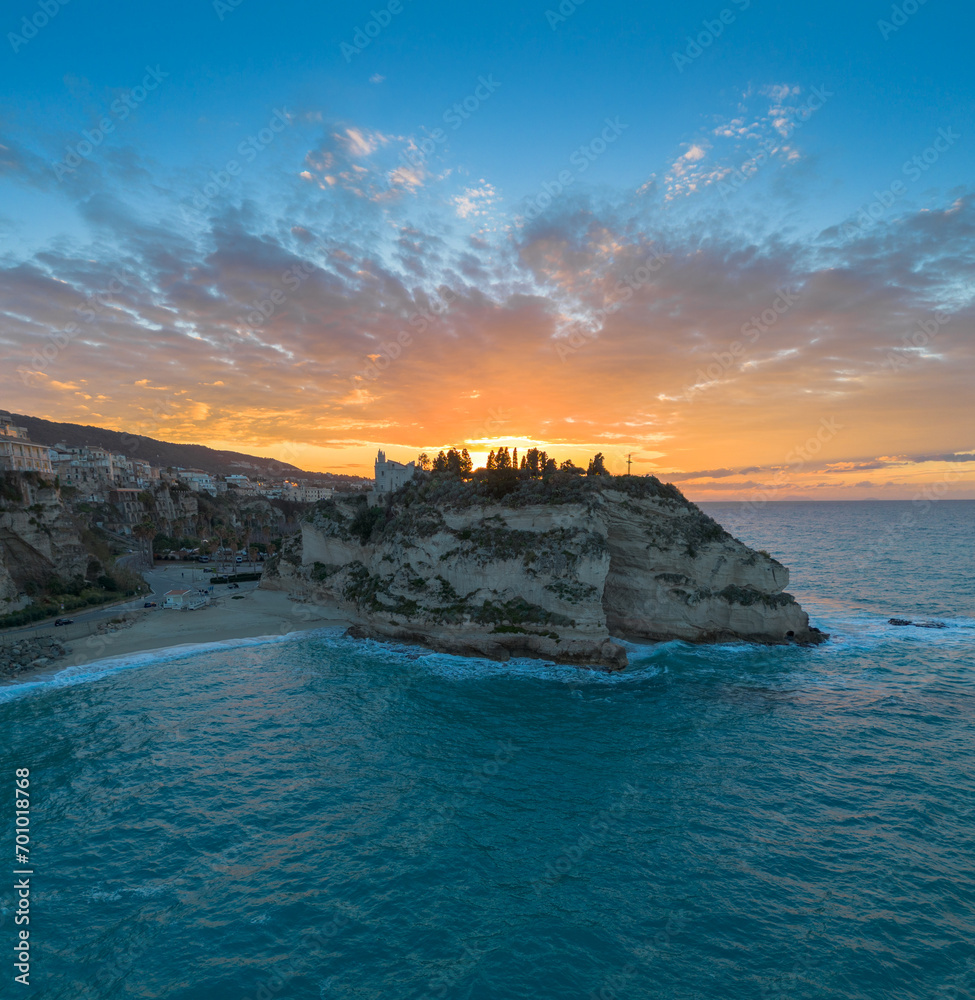 Wall mural view of rotonda beach and the colourful old town of tropea in calabria at sunset