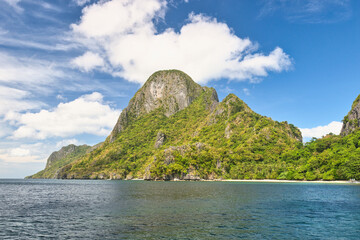 PALAWAN, PHILIPPINES - DECEMBER 21, 2023: Tropical Shimizu Island and paradise beach, El Nido, Palawan, Philippines. Tour A Route. Coral reef and sharp limestone cliffs. 