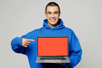 Young middle eastern man wear blue hoody casual clothes hold use work point finger on laptop pc...