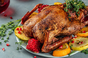 Traditional roasted stuffed Christmas Peking duck with herbs on a dark background. top view. copy...