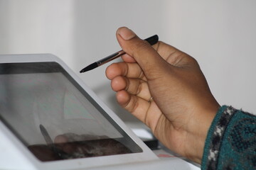 A hand Holding a Touch Pen.  Selective Focus. India