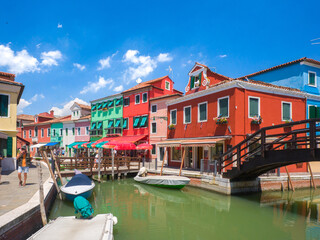 Bridge over a channel in town surrounded by colourful buildings (Burano, Italy)