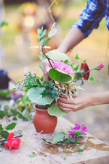Woman florist making bouquet  outdoors