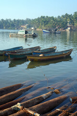Traditional fishing boats anchored on fishing jetty of Devgad, Maharashtra, India.