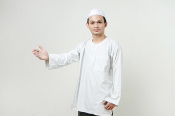 happy asian muslim man offering handshake gesture. People religious Islam lifestyle concept. celebration Ramadan and ied Mubarak. on isolated background.