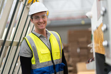 Portrait Caucasian businessman workers with machine at Kraft paper stock in warehouse