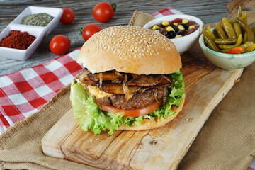 hamburger with cutlet grilled on a wooden surface