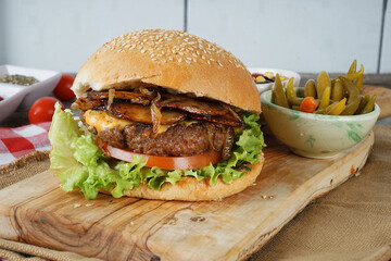 hamburger with cutlet grilled on a wooden surface