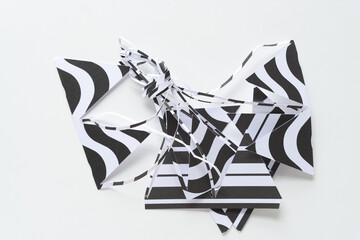 black and white paper shapes tied together in a pile