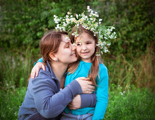 Pleased mother embracing daughter