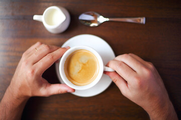 Cropped shot of young businessman with cup of coffee