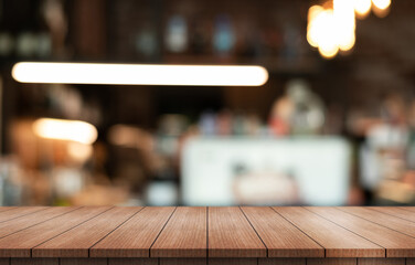 Empty wooden table top with lights bokeh on blur restaurant background.