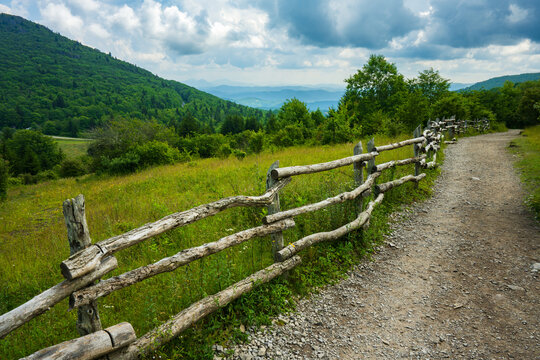 A long wooden fence along a worn trail in a mountain meadow in Grayson Highlands State Park, Virginia