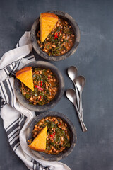 Overhead view of black eye peas and collard greens with slices of corn bread; New Year's southern food tradition in the US; copy space