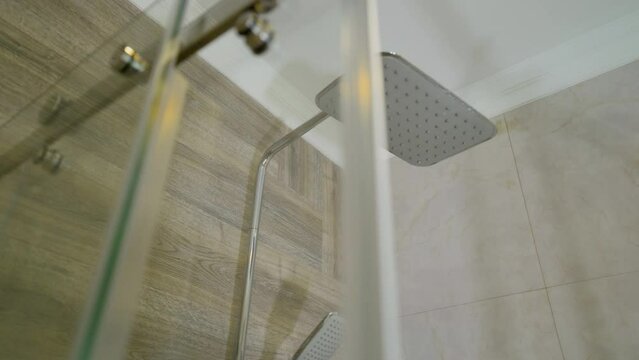 Modern bathroom. Luxury shower cabin. Shower cabin in a hotel. Shower cabin with glass partition and shower head built into the wall.