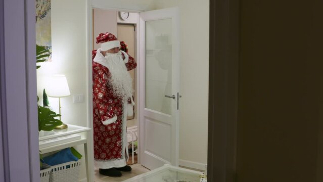father in Russian Ded Moroz costume prepares to wish his child a Happy New Year in Russia