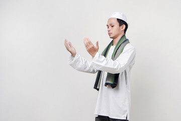 happy asian muslim man praying hand gesture, holding palm face up. People religious Islam lifestyle concept. celebration Ramadan and ied Mubarak. on isolated background.