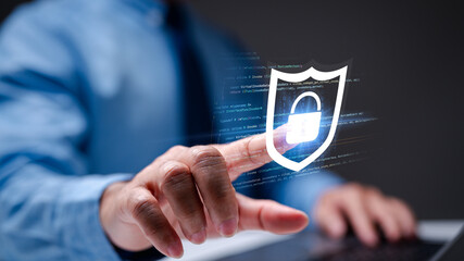 Administrator safeguards cyberspace with a laptop, implementing robust firewall technology for...