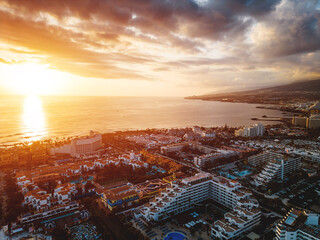 sunset at ocean shore with hotels and villas of Tenerife, Canary island, aerial